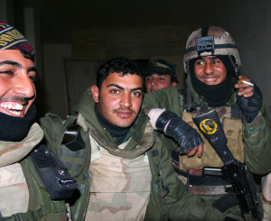 Iraqi soldiers celebrate after a raid.