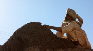 A man builds a wall in Karamanda, Afghanistan